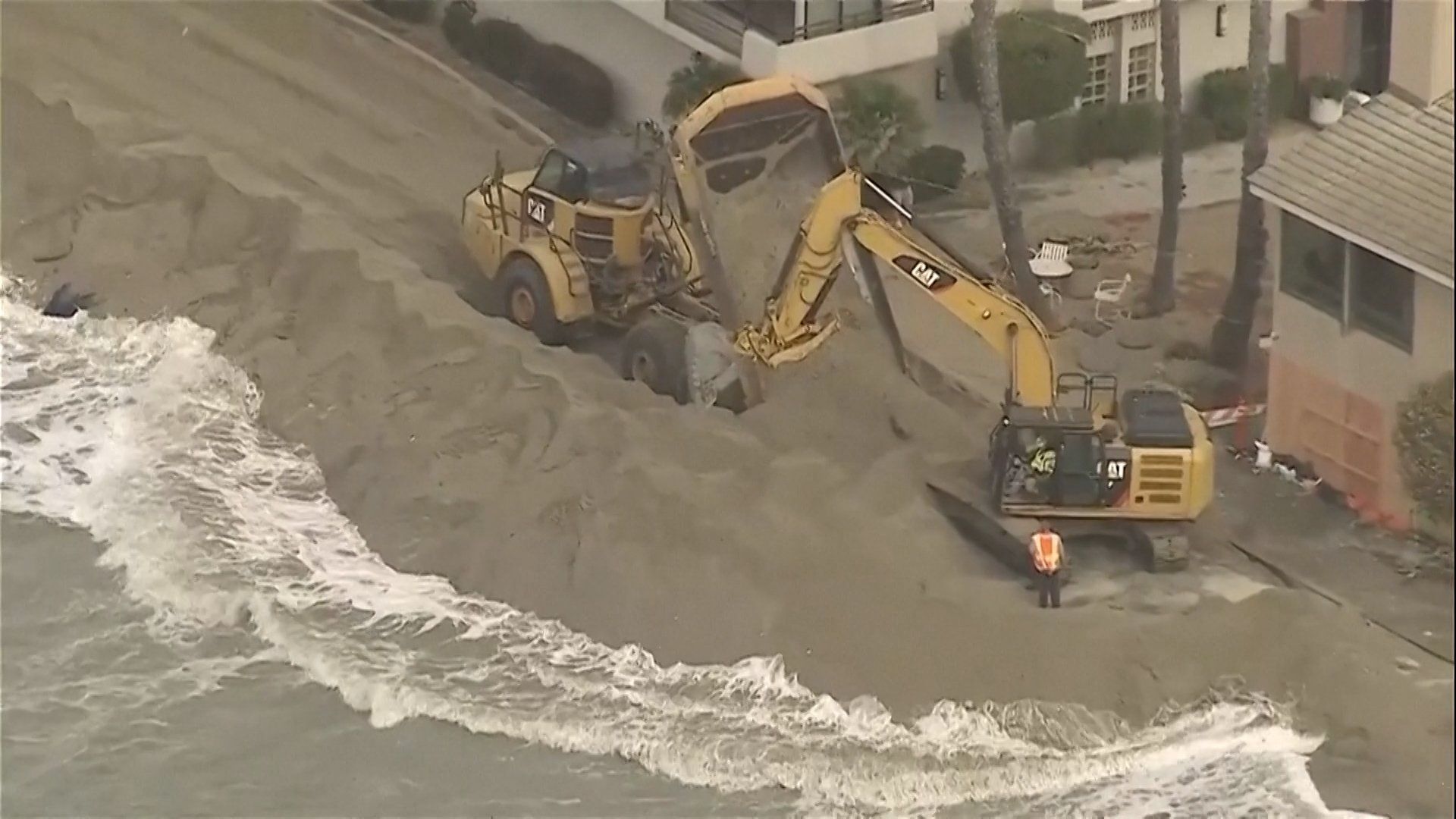 Waves crash into homes as excavators try to protect California properties